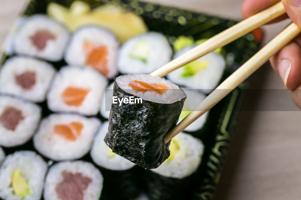 CLOSE-UP OF PERSON HAND HOLDING FOOD