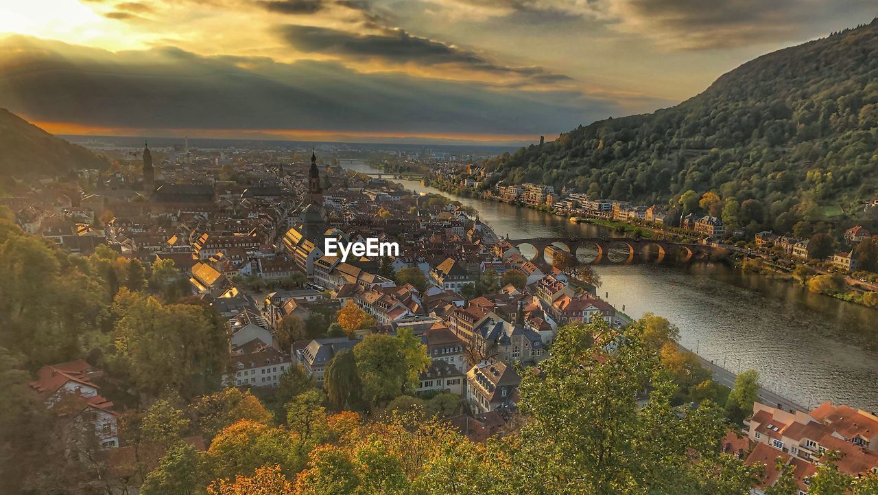 High angle view of townscape by river against sky