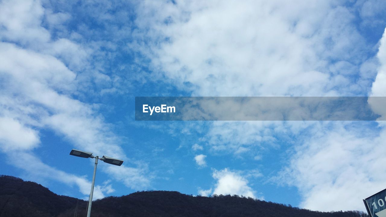 SCENIC VIEW OF MOUNTAINS AGAINST CLOUDY SKY