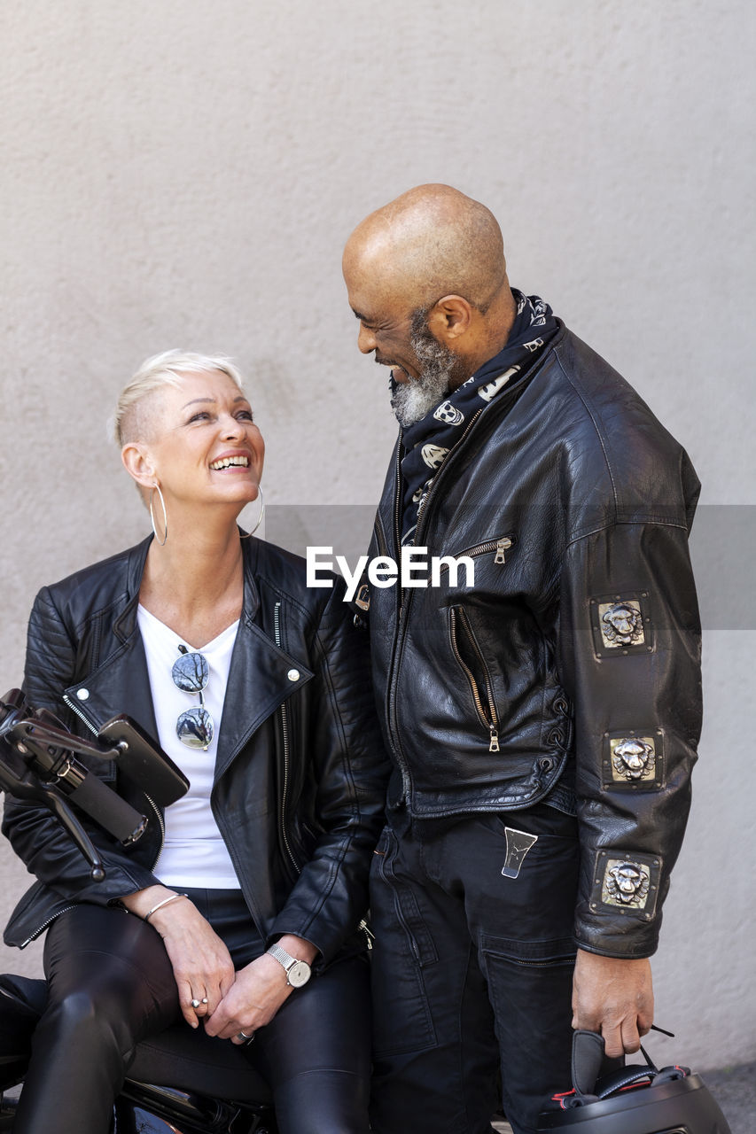 Cool mature biker couple in leather clothes