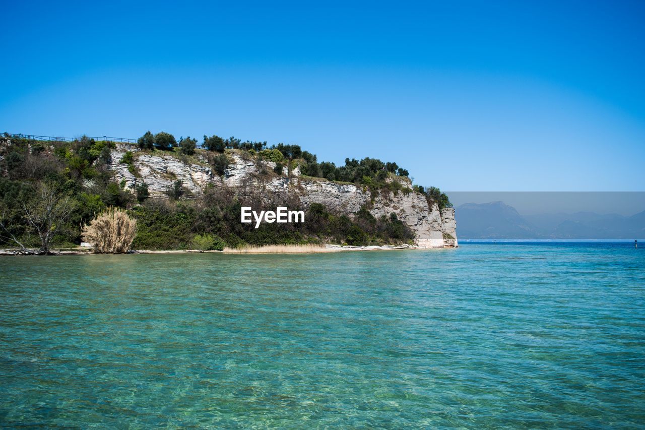 Scenic view of sea against clear blue sky