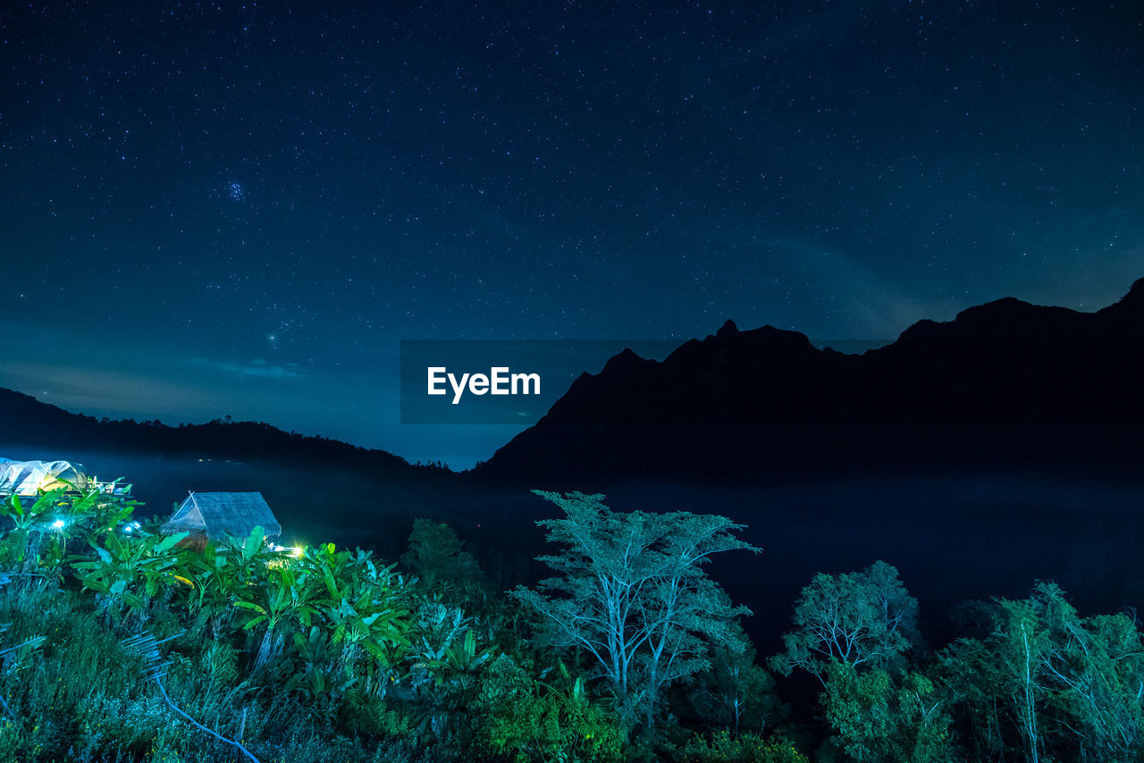 Scenic view of mountains against blue sky at night