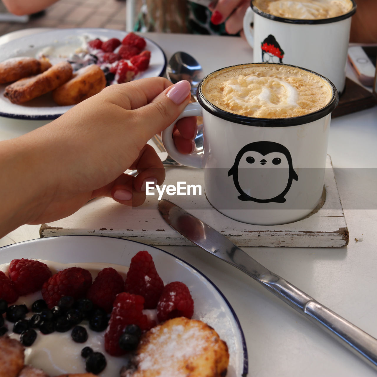 Midsection of coffee cup on table