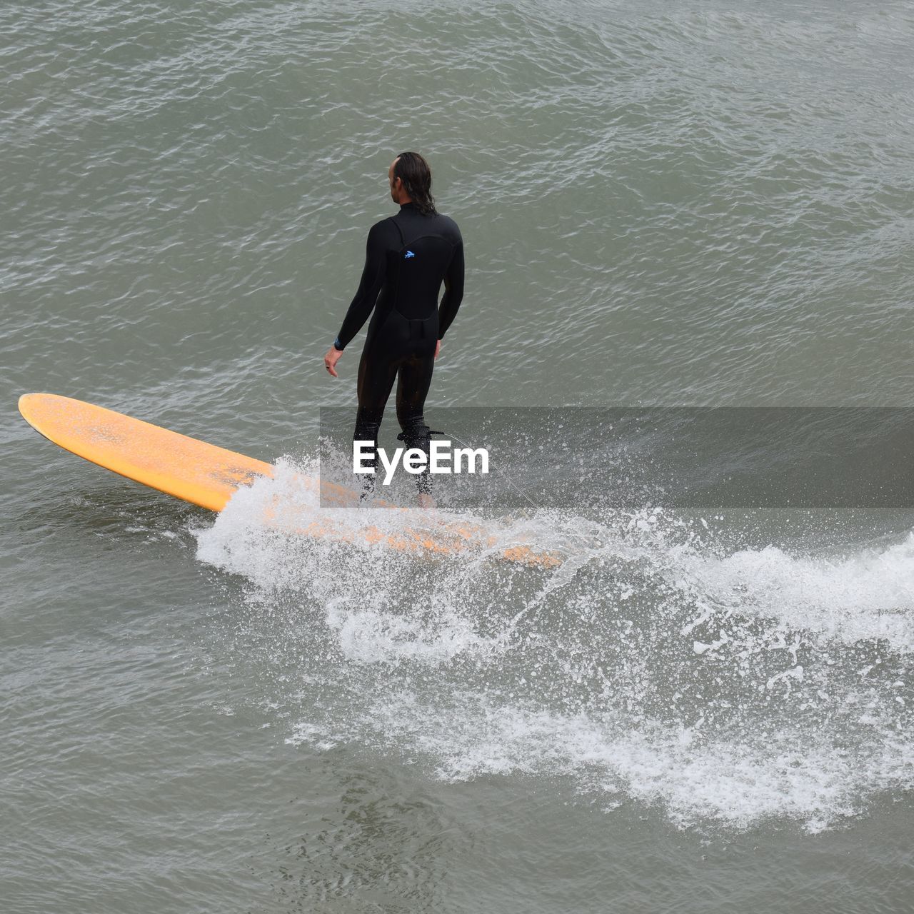 MAN SURFING IN SEA