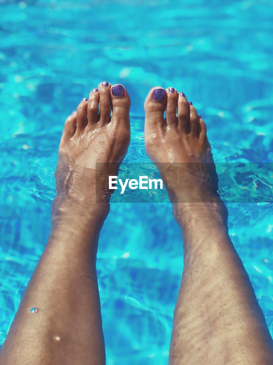 Low section of woman in swimming pool