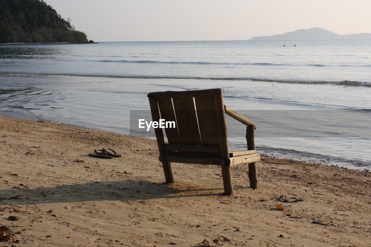 Wooden chair on shore at beach