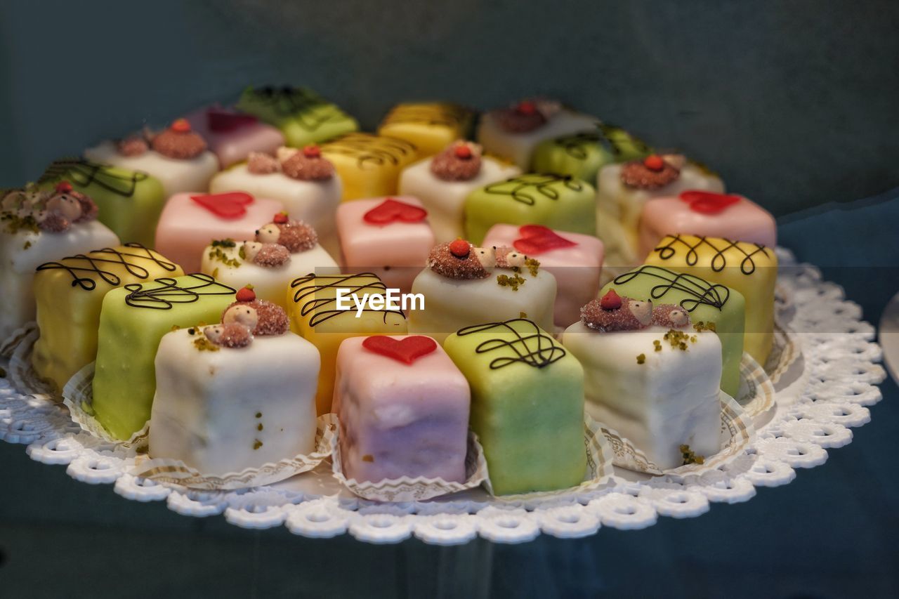 High angle view of decorated small cakes on plate