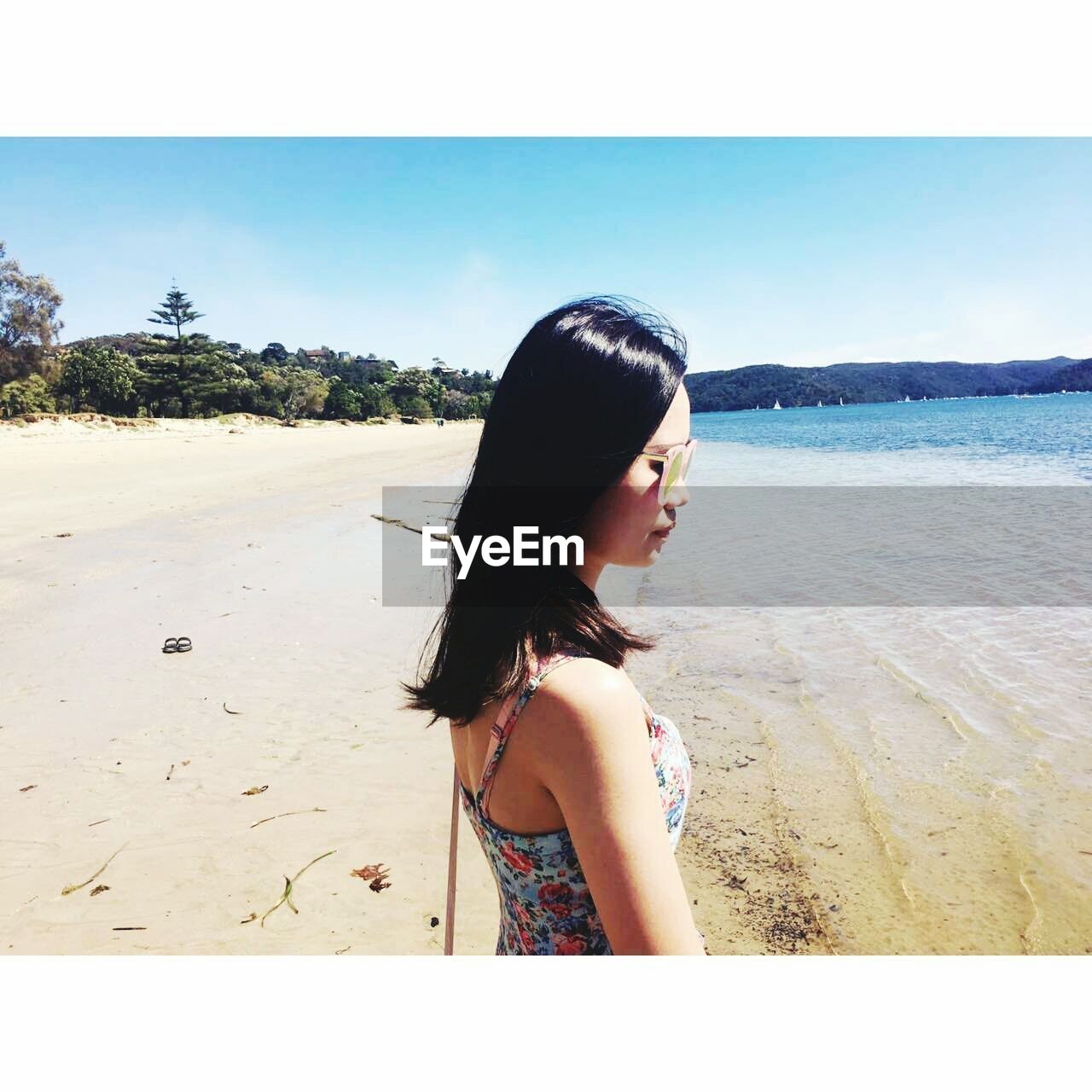 PORTRAIT OF YOUNG WOMAN AGAINST SEA