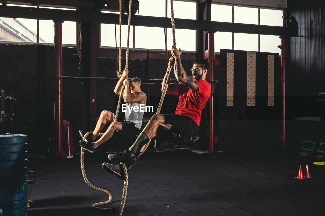 low angle view of woman swinging at amusement park