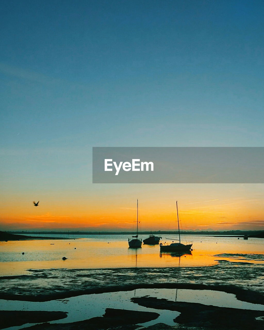 Scenic view of sea against clear sky during sunset