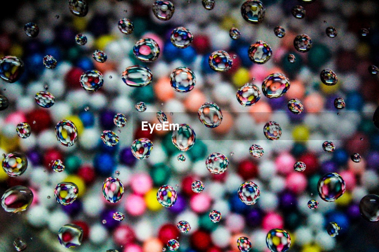 FULL FRAME SHOT OF BUBBLES WITH RAINBOW