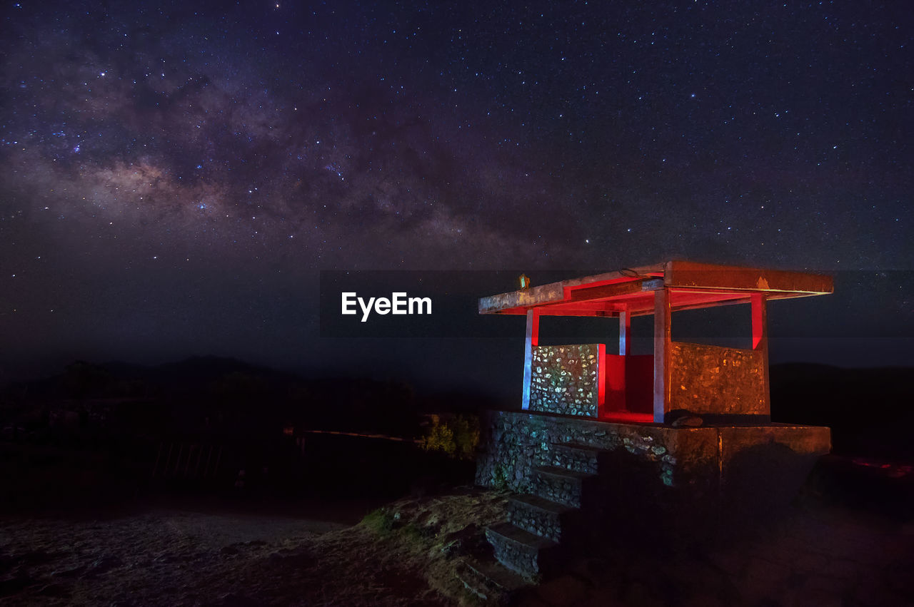 Illuminated structure against sky at night