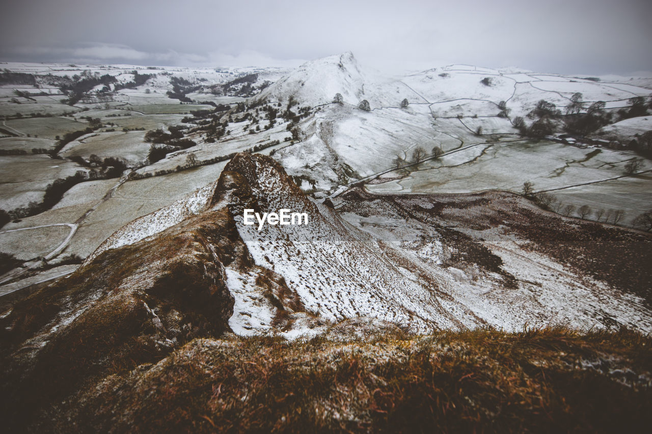 Scenic view of snow covered mountains against sky