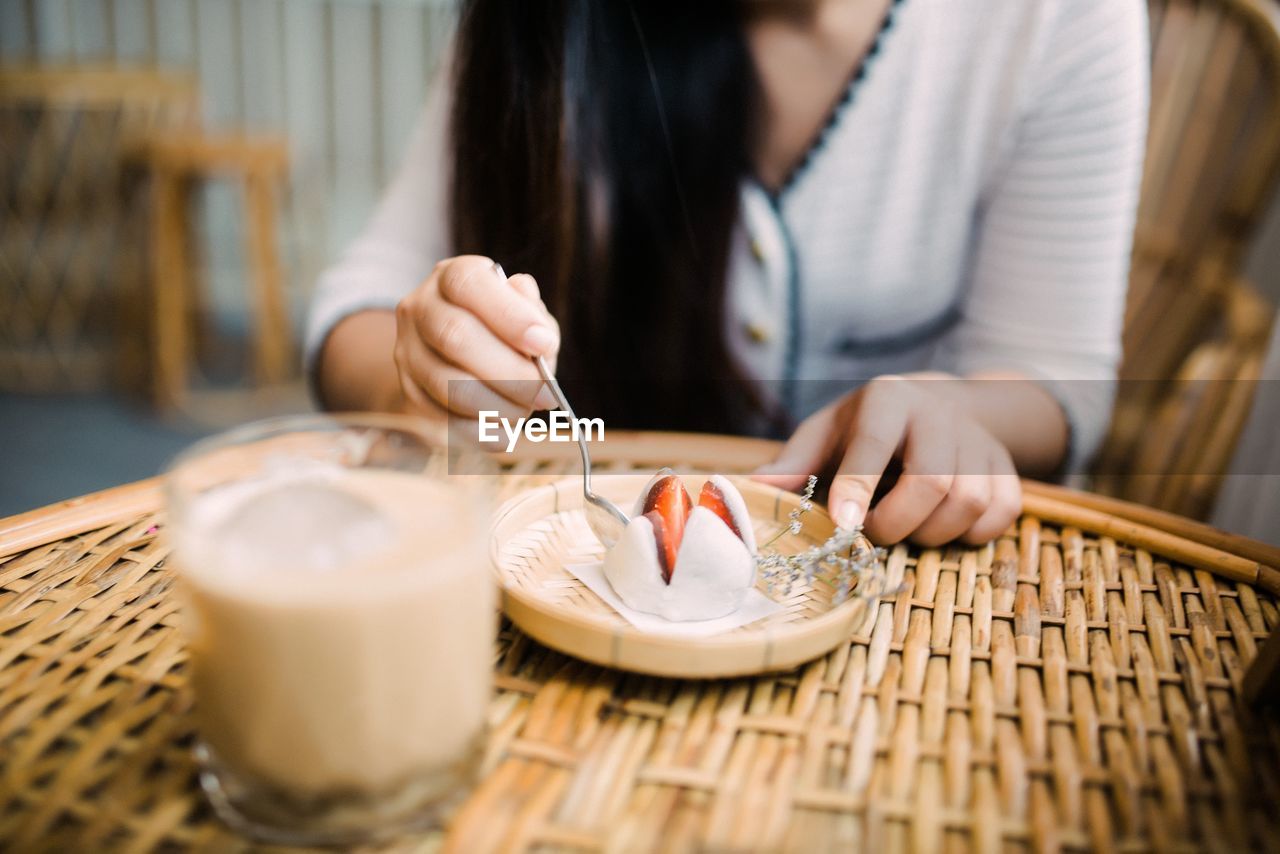 Midsection of woman working on table