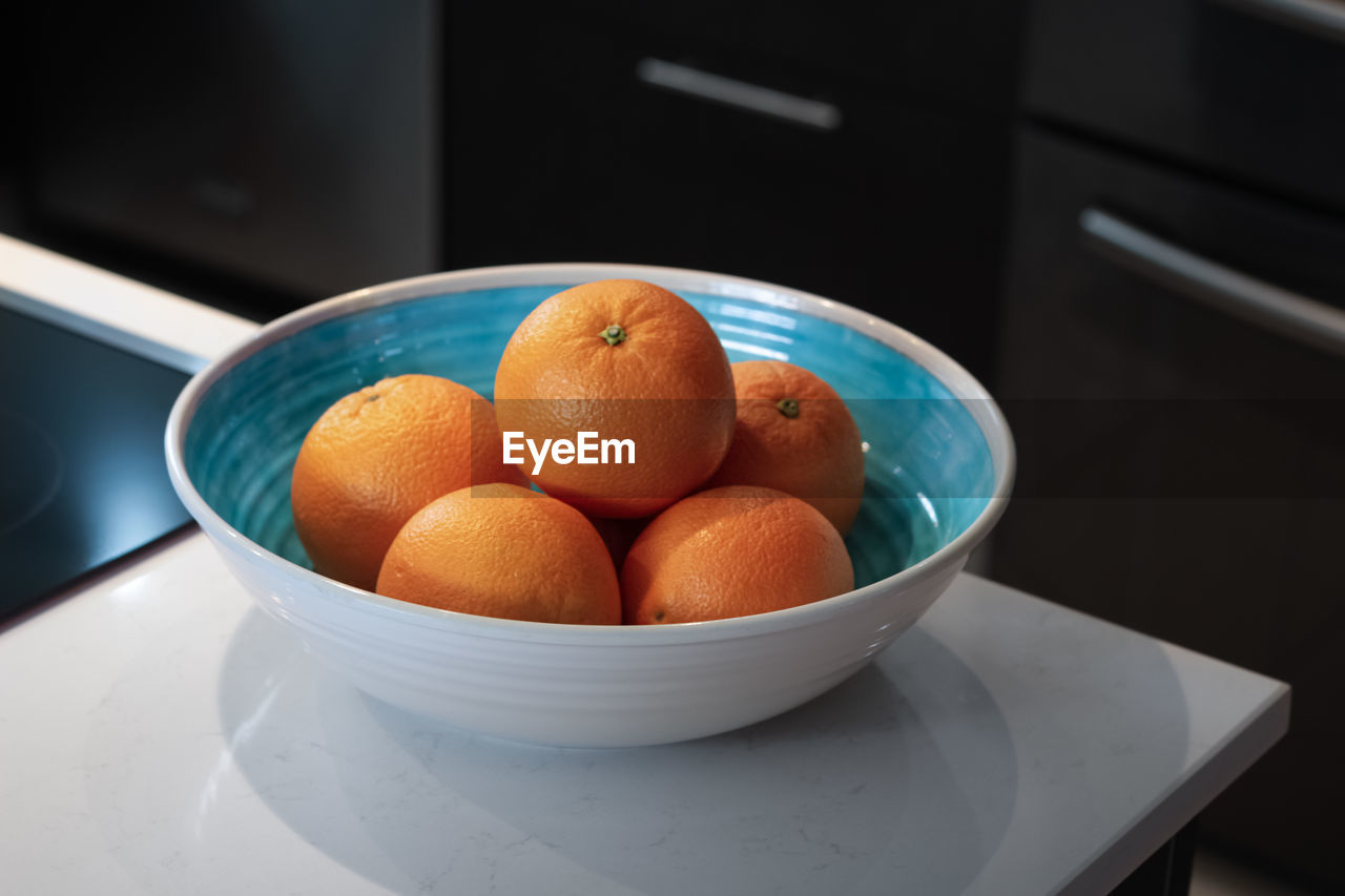 High angle view of oranges in bowl at home 