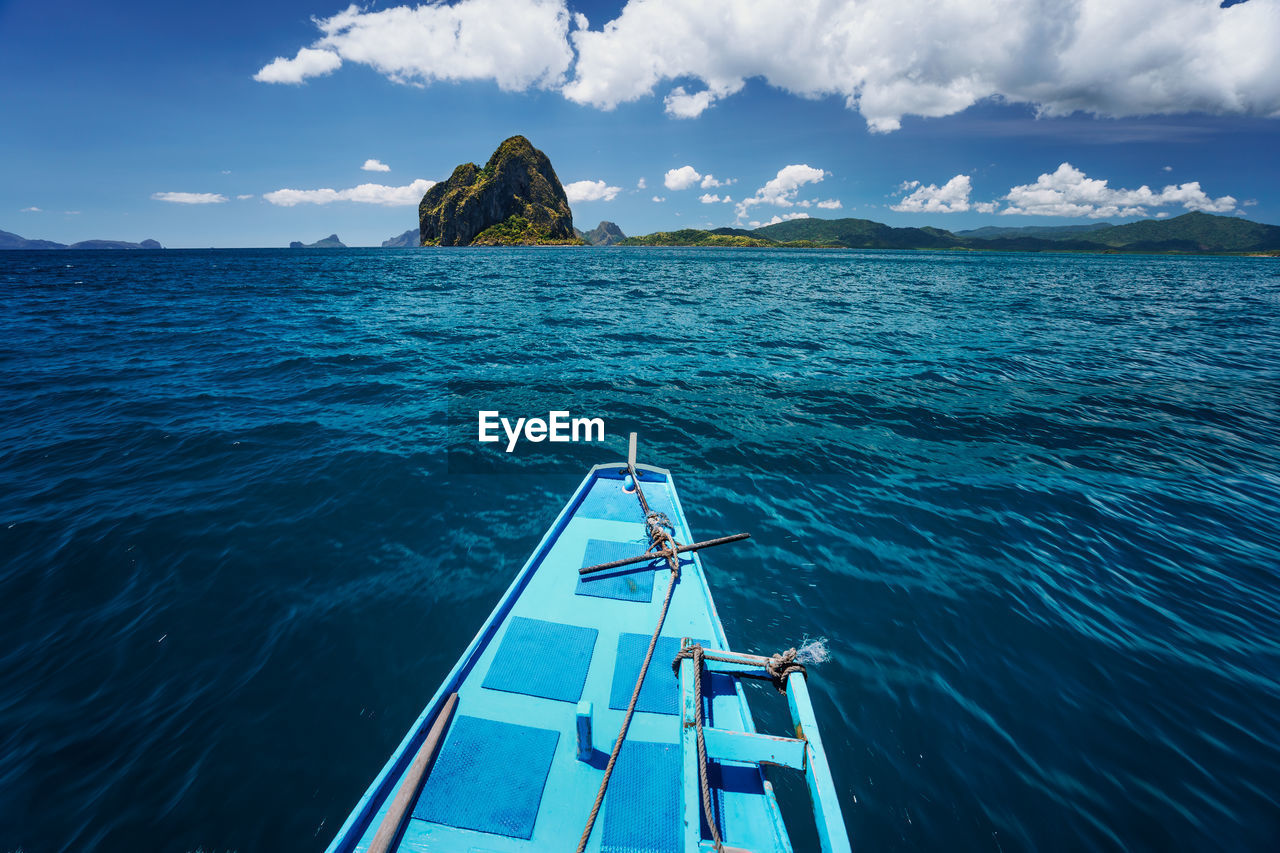 SAILBOAT ON SEA AGAINST BLUE SKY