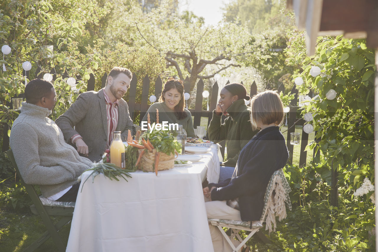 Friends having meal in garden