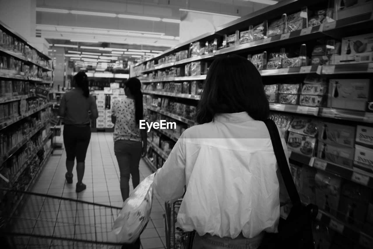 Rear view of customers at supermarket