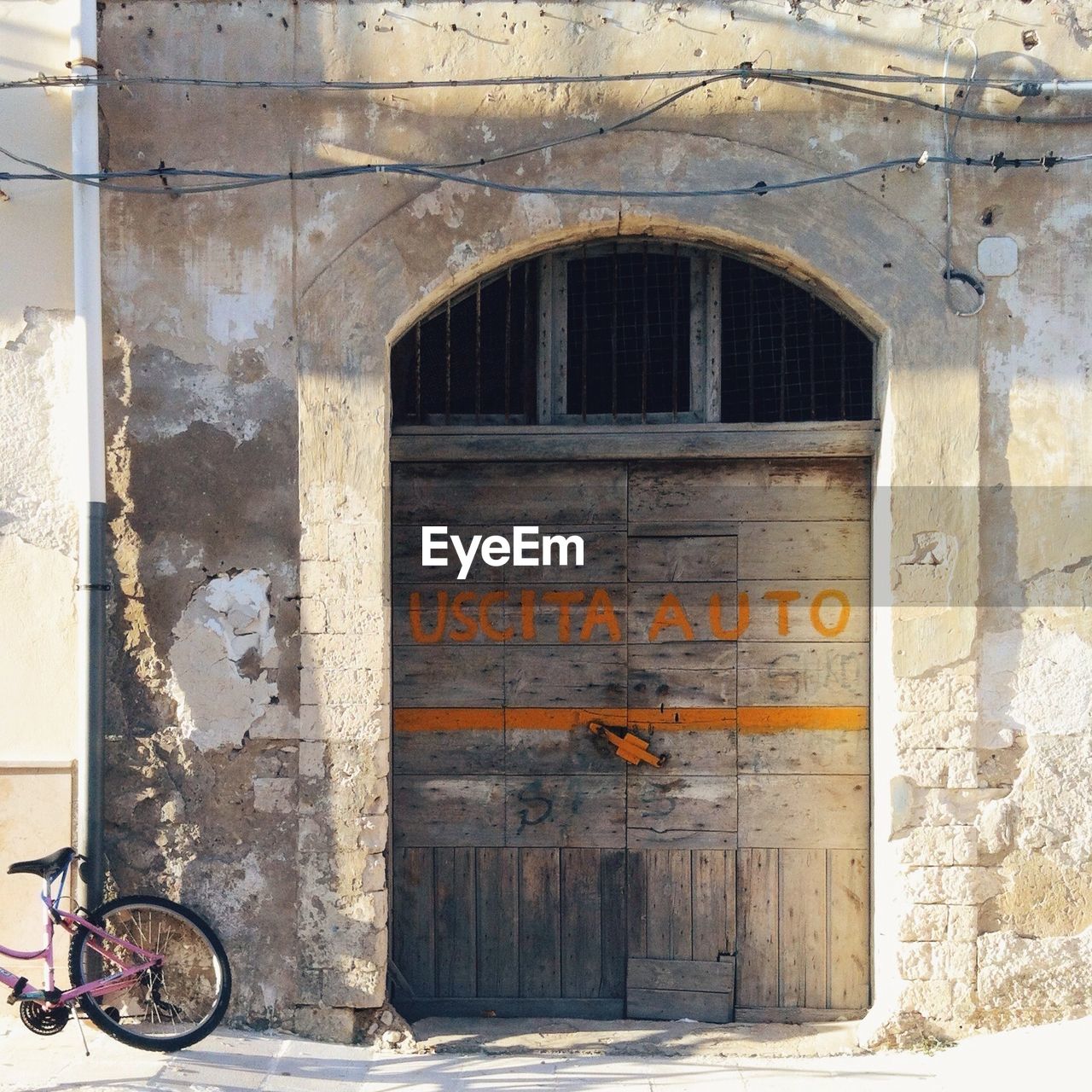 Text on wooden door of abandoned building