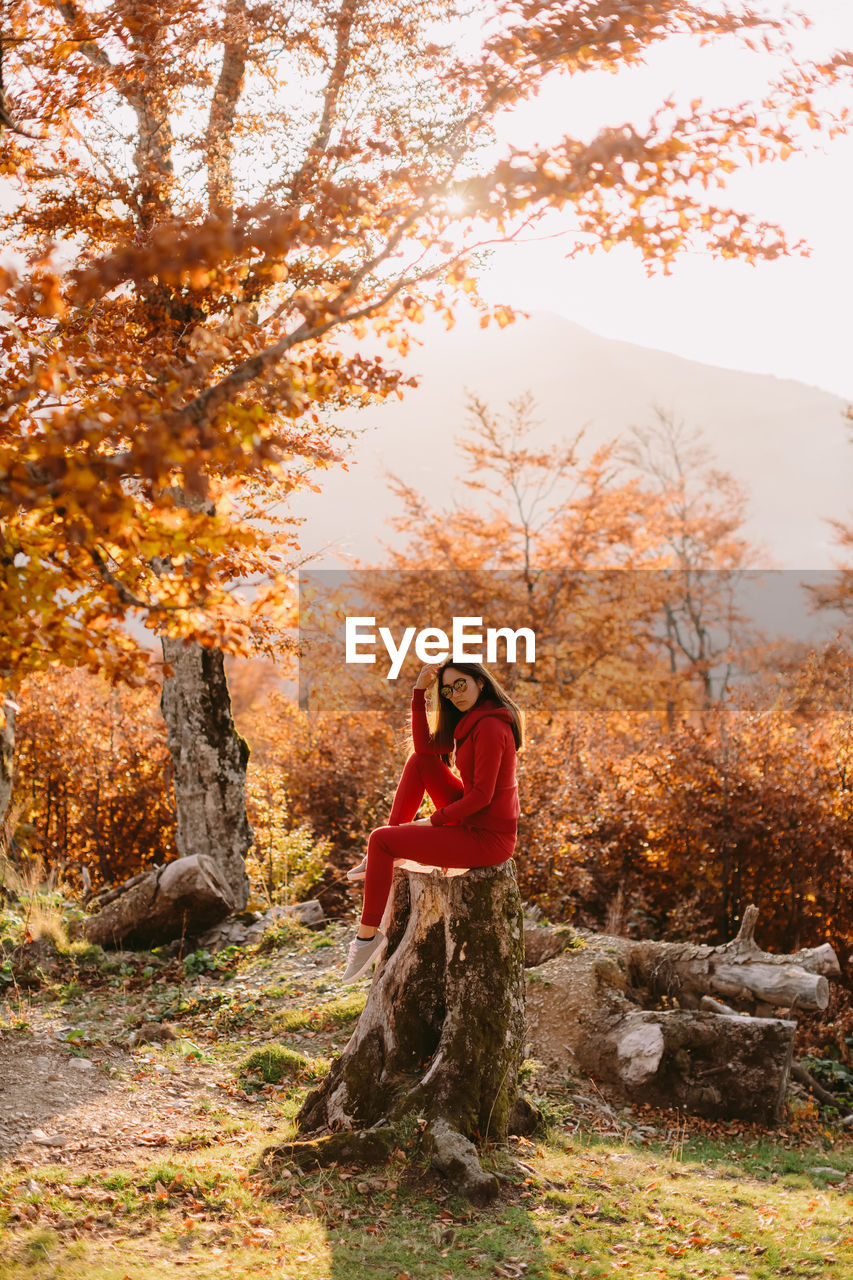 FULL LENGTH OF WOMAN STANDING IN FOREST