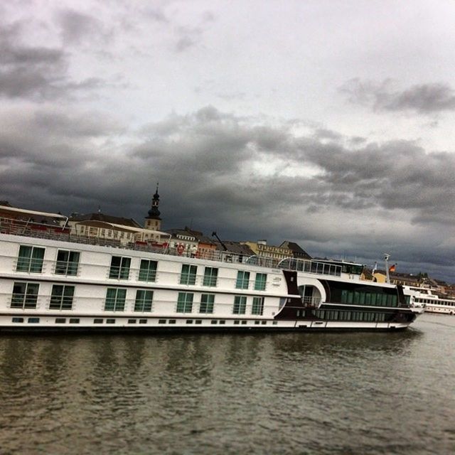 VIEW OF BUILDINGS AGAINST CLOUDY SKY