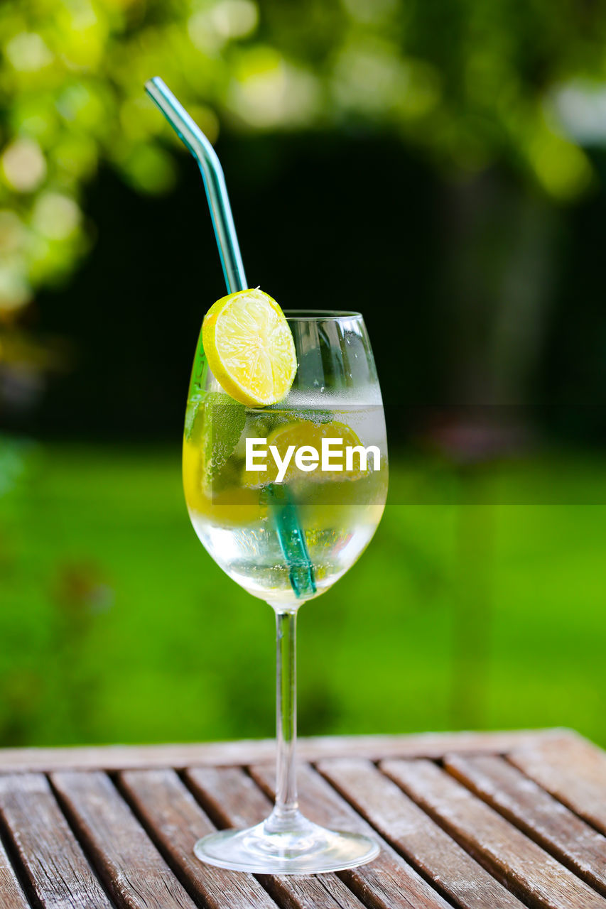 CLOSE-UP OF DRINK ON TABLE AGAINST GLASS