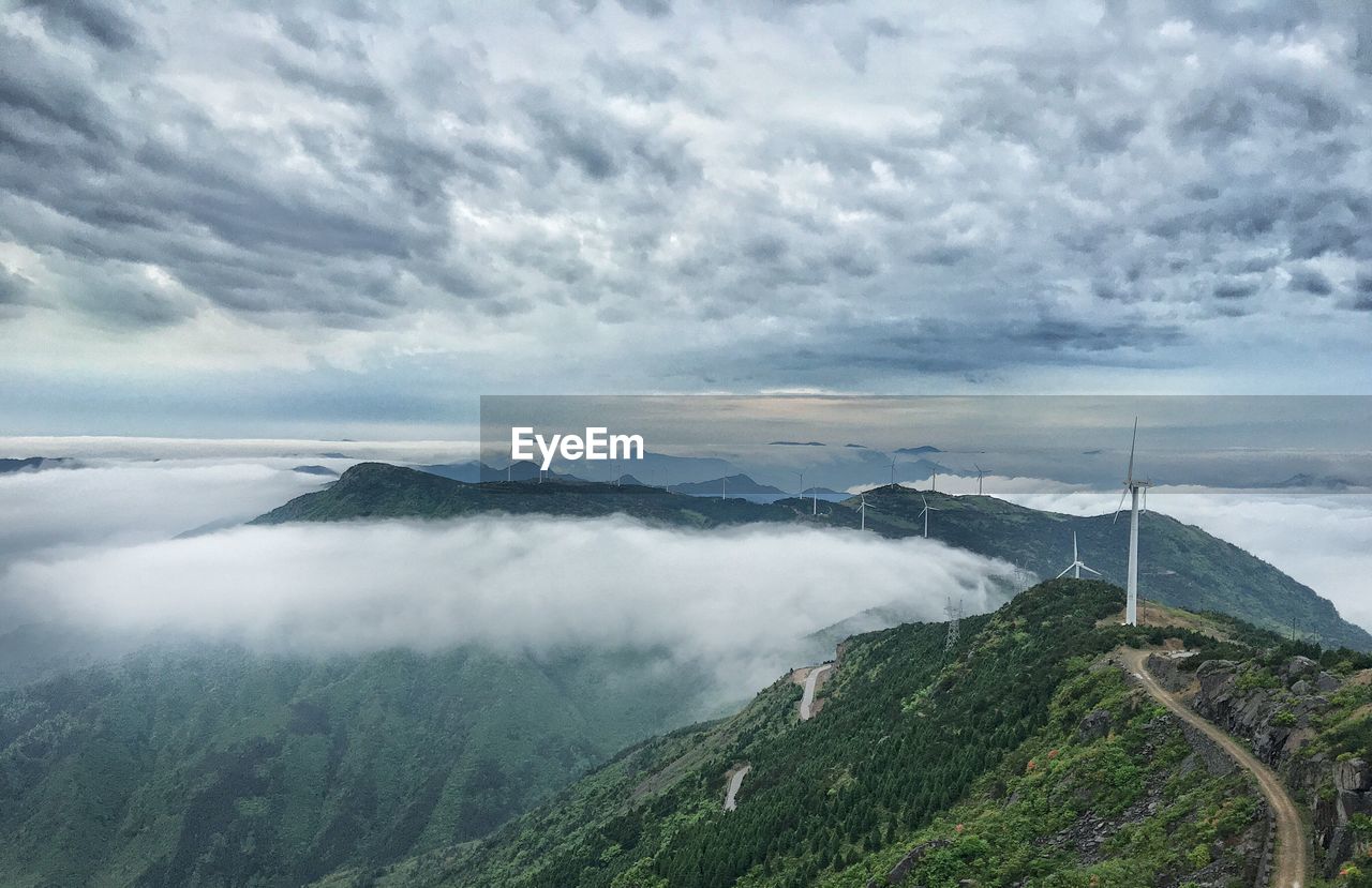 Scenic view of mountains against cloudy sky