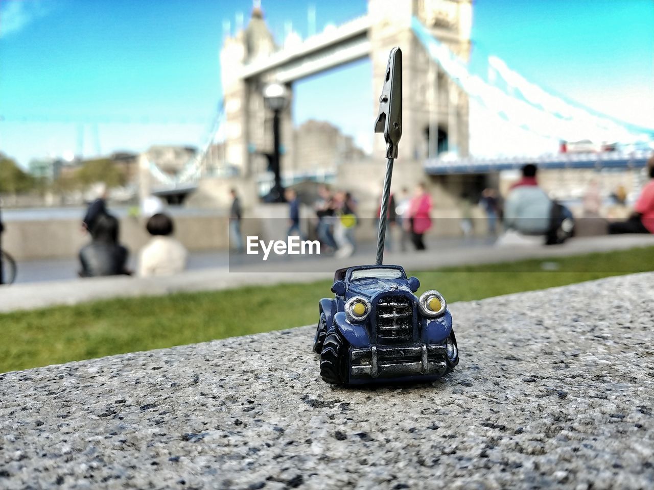 CLOSE-UP OF CAR ON STREET AGAINST SKY