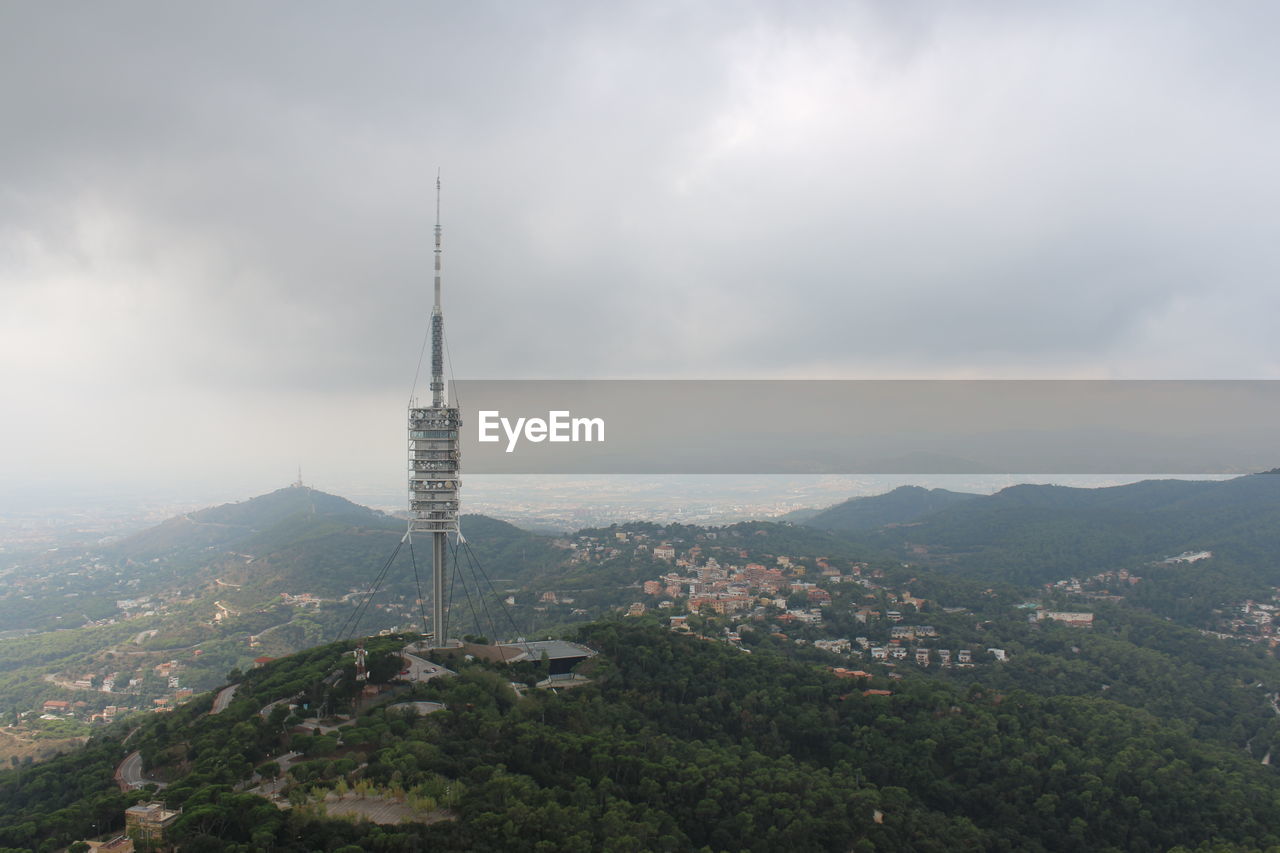 Aerial view of buildings in city against sky