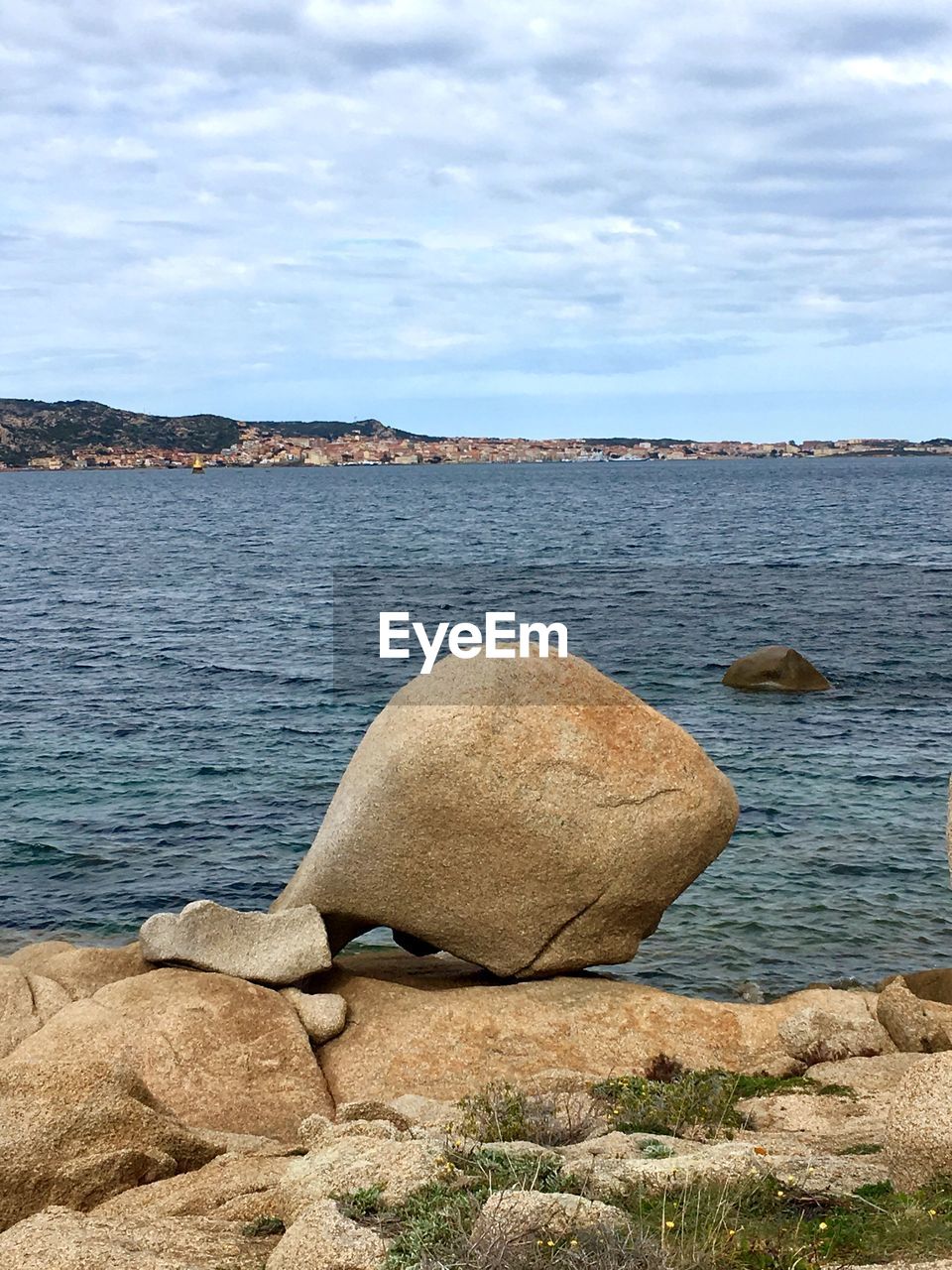 ROCK ON BEACH AGAINST SKY