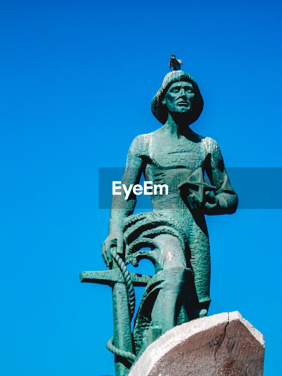 Low angle view of statue against blue sky