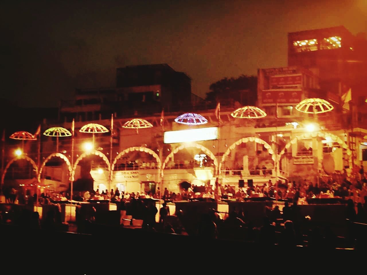 VIEW OF ILLUMINATED STREET LIGHTS AT NIGHT