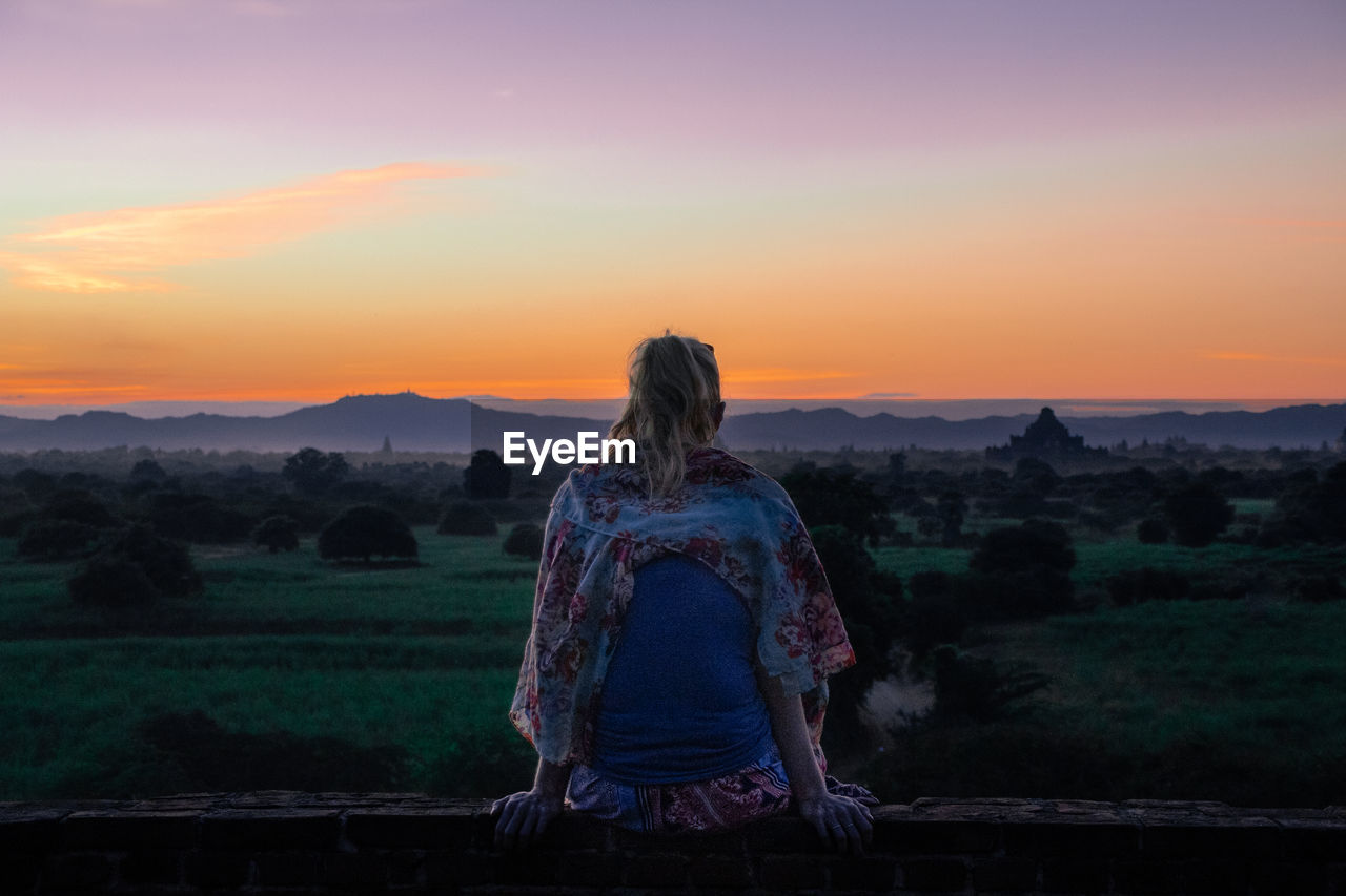 Girl watching sunset at bagan, myanmar