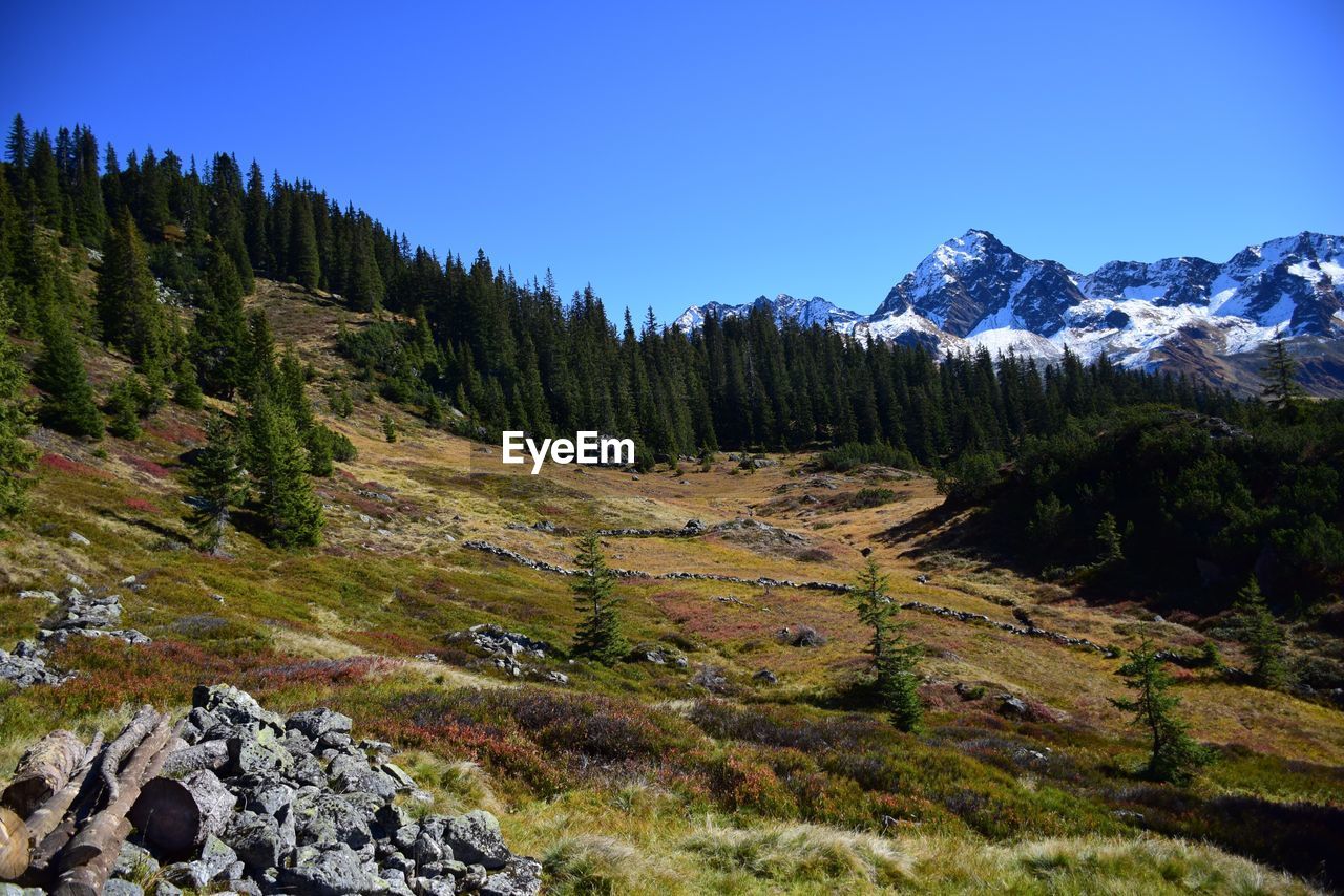 Scenic view of mountains against clear blue sky