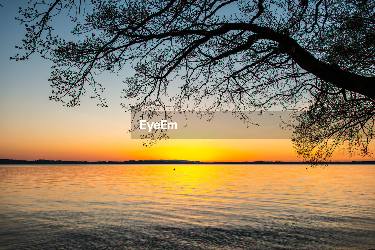 SCENIC VIEW OF LAKE AGAINST ORANGE SKY