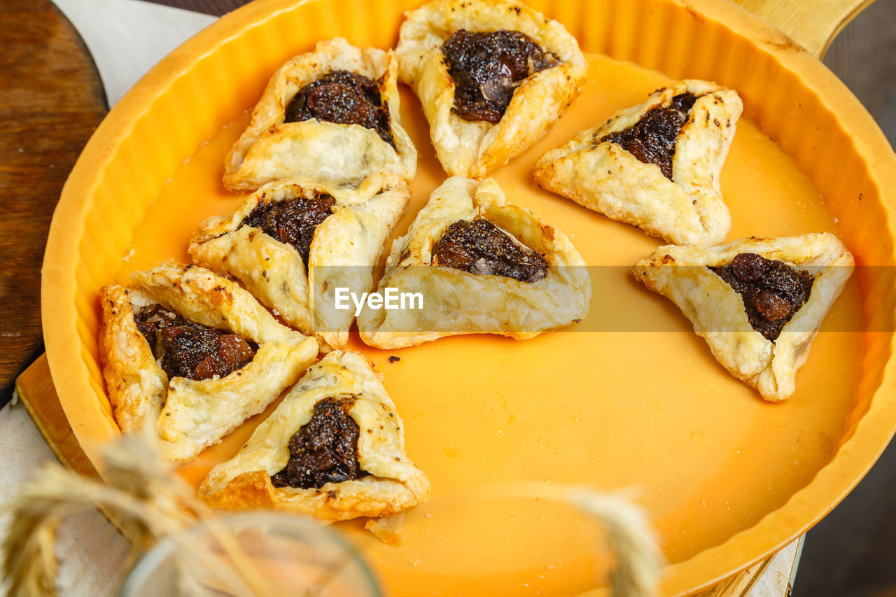 Gomentash biscuits for purim holiday fresh in a baking dish. horizontal photo