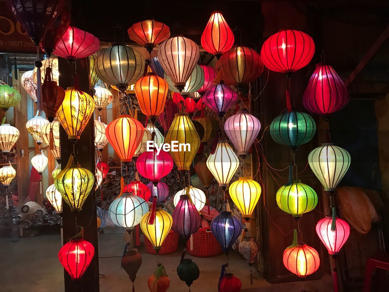 Illuminated lanterns hanging at night for sale