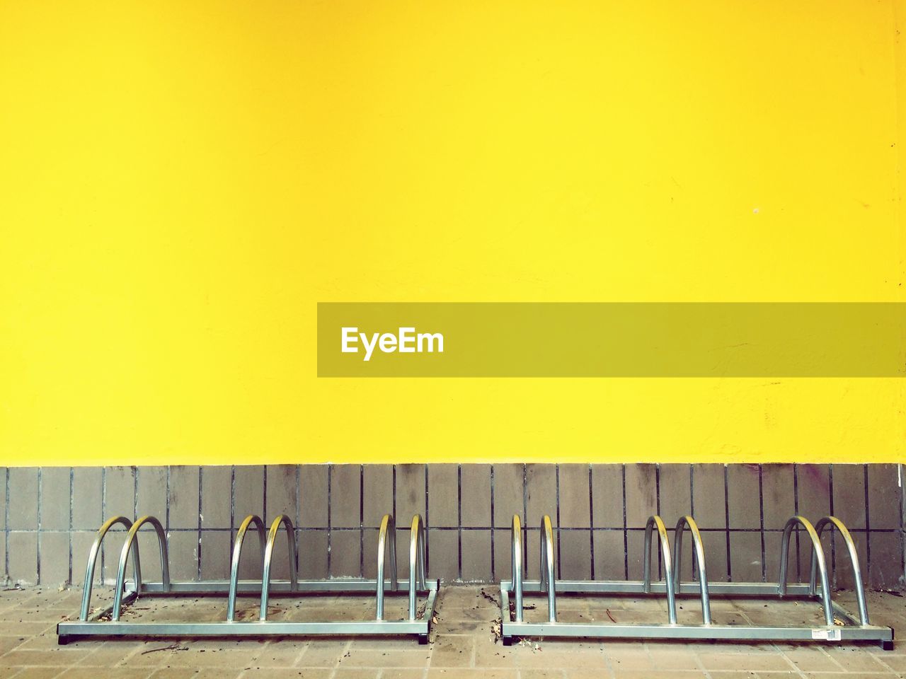 Bicycle rack against yellow wall