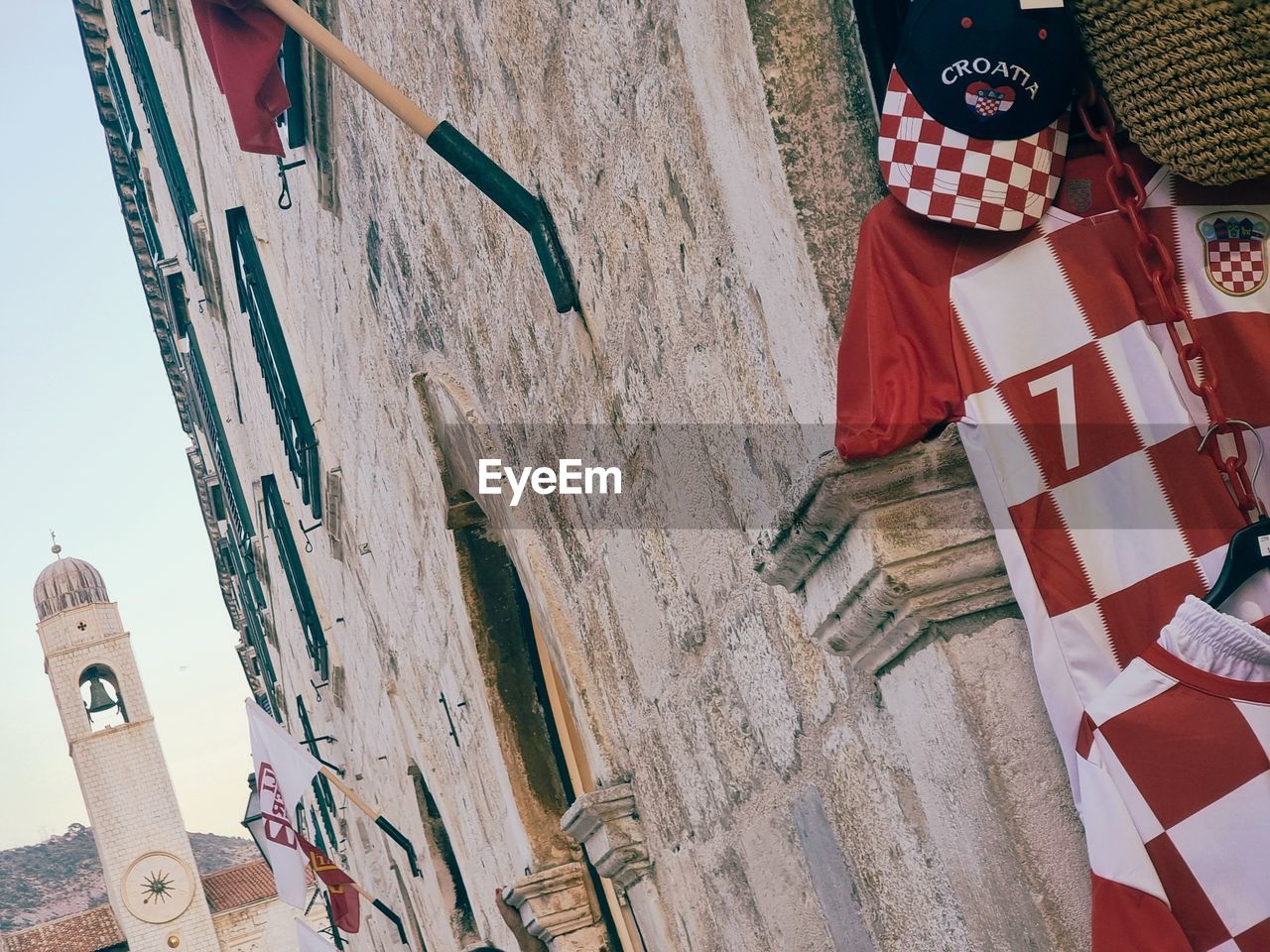HIGH ANGLE VIEW OF FLAGS HANGING BY BUILDING