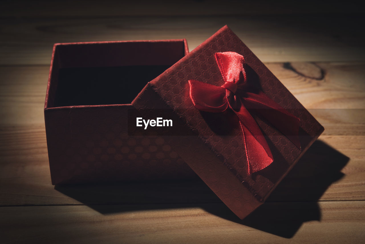 High angle view of gift box on wooden table