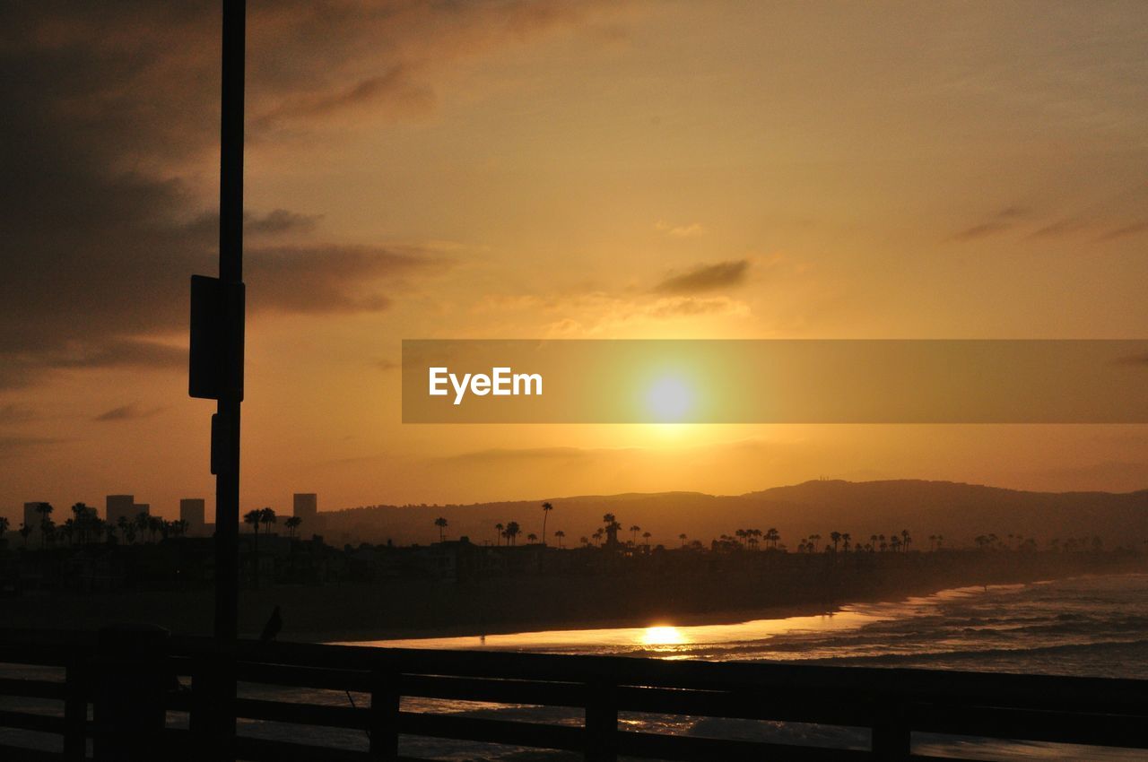Scenic view of beach against sky during sunrise