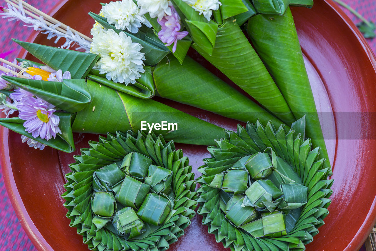 Flower in the banana leaf cones with joss-sticks and candle for pray. northern thailand culture.