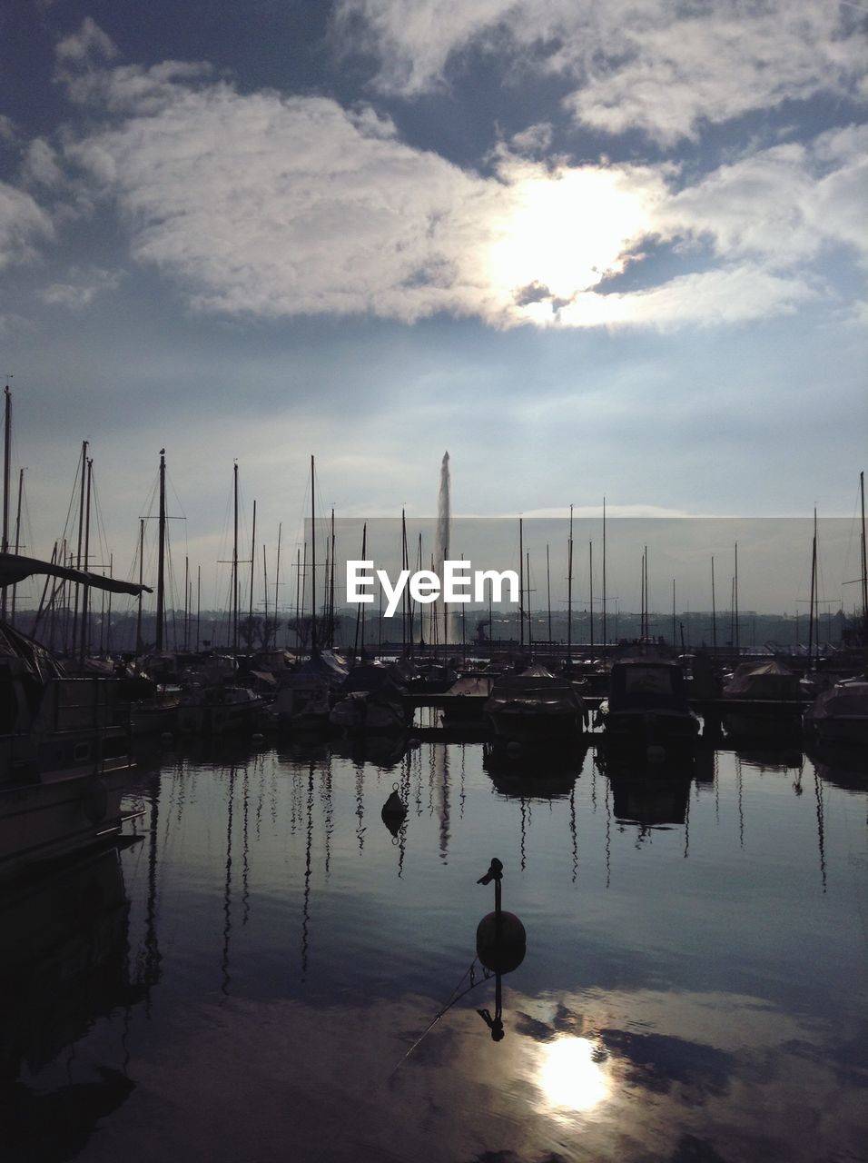 SILHOUETTE BOATS MOORED AT HARBOR AGAINST SKY