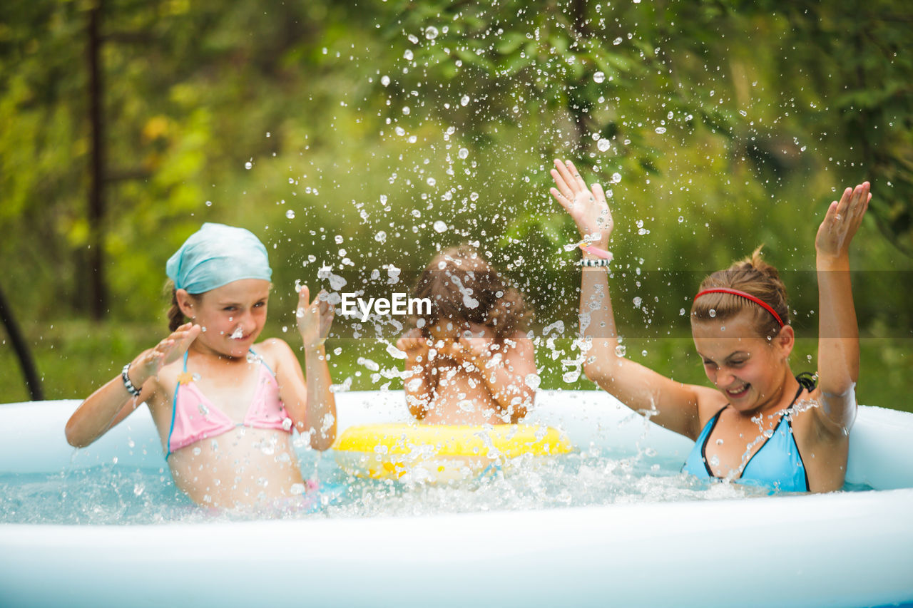 Happy girl enjoying in swimming pool