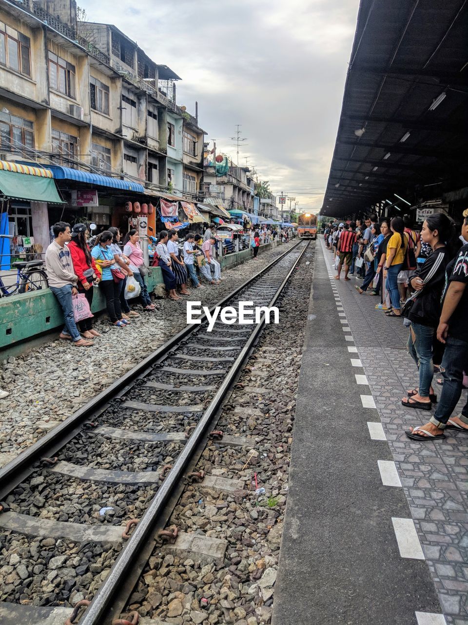 GROUP OF PEOPLE ON RAILROAD TRACK