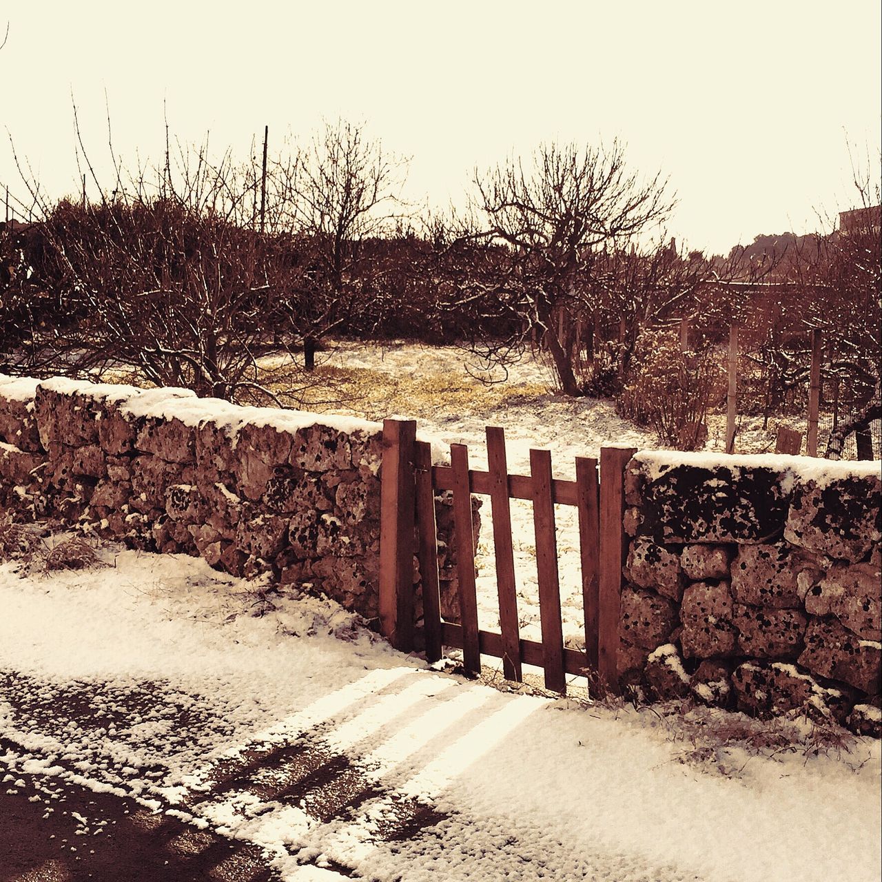 Small wooden gate at stone walls