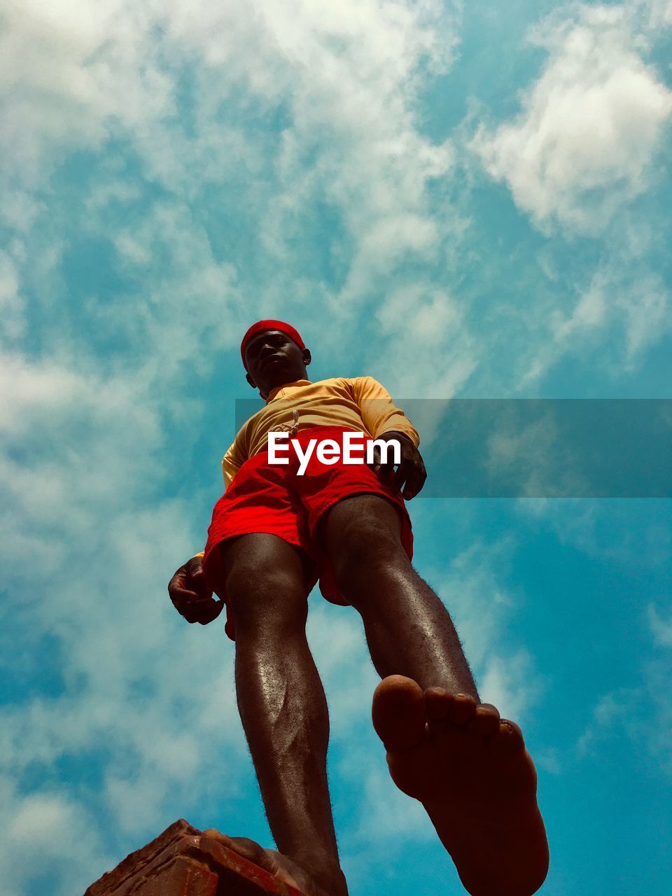 LOW ANGLE VIEW OF MAN AGAINST SKY