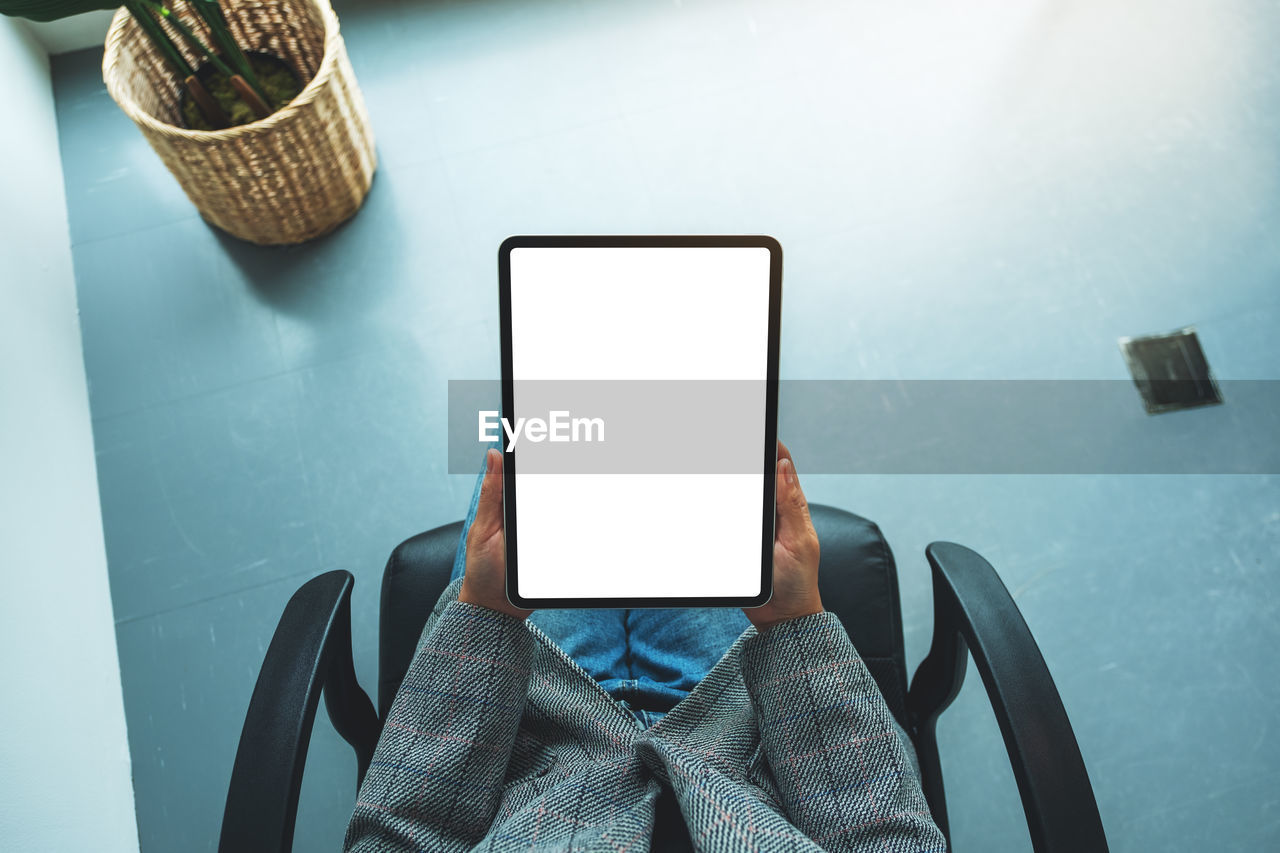 high angle view of woman using smart phone on table