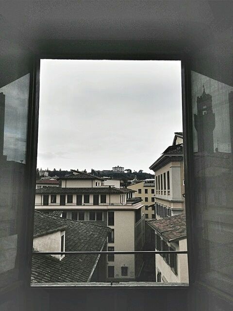 VIEW OF BUILDINGS THROUGH WINDOW