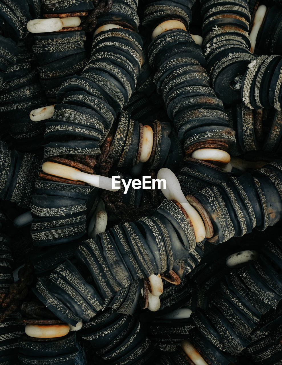 large group of objects, backgrounds, tire, full frame, abundance, automotive tire, no people, close-up, food, arrangement, still life, iron, indoors, black, high angle view, pattern, repetition, in a row, food and drink